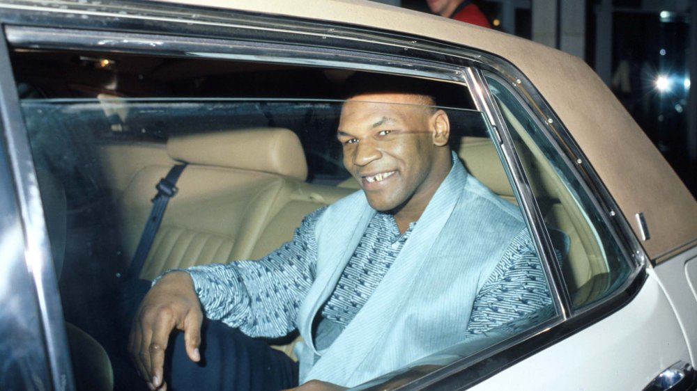 Mike Tyson smiling in a car