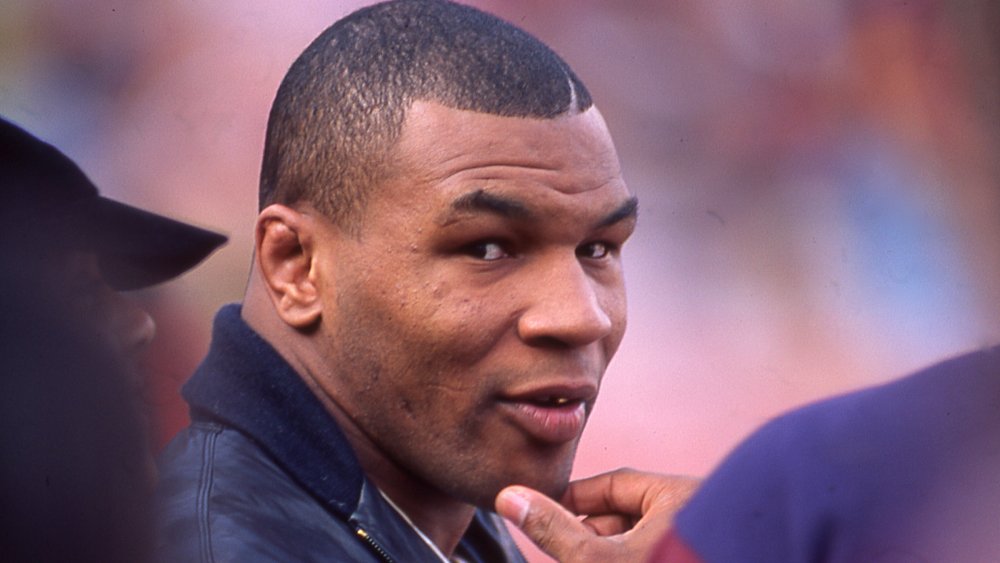 Mike Tyson, looking back at camera in a crowd