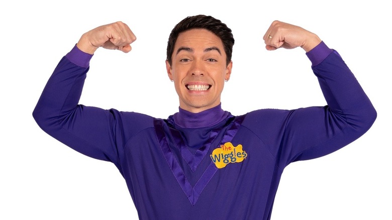 John Adamo Pearce posing muscles Wiggles purple shirt