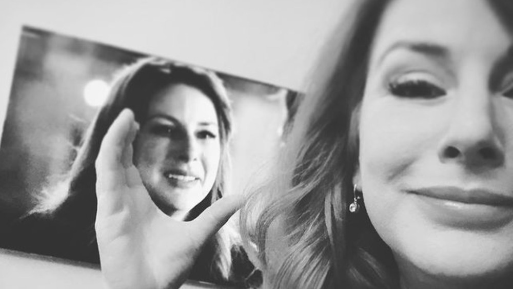 Diane Neal posing with herself on television