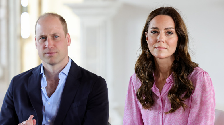 Prince William and Kate Middleton looking serious side-by-side