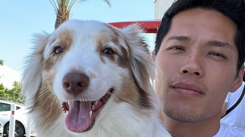 Tim Chung holding dog selfie