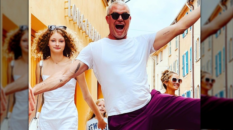 Eric Dane laughing and jumping with his family