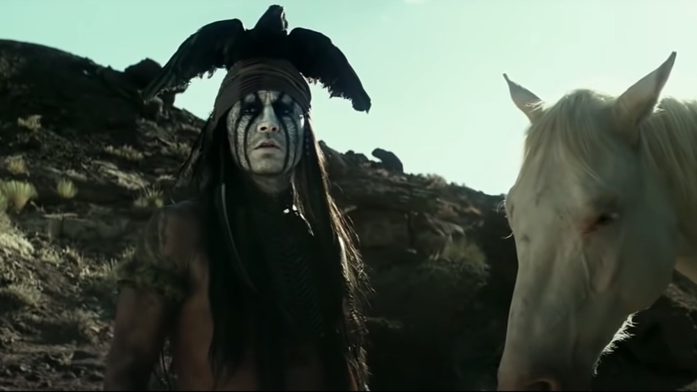 Johnny Depp in The Lone Ranger, standing next to horse