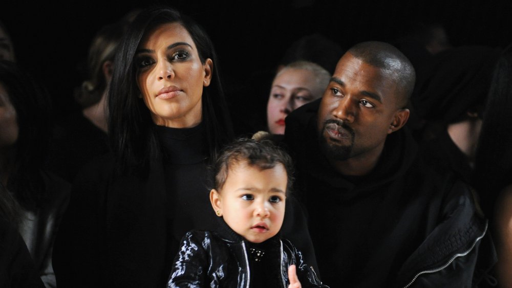 Kim Kardashian, North West and Kanye West attend the Alexander Wang Fashion Show during Mercedes-Benz Fashion Week