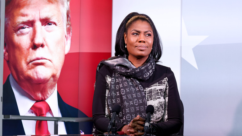 Omarosa with clasped hands