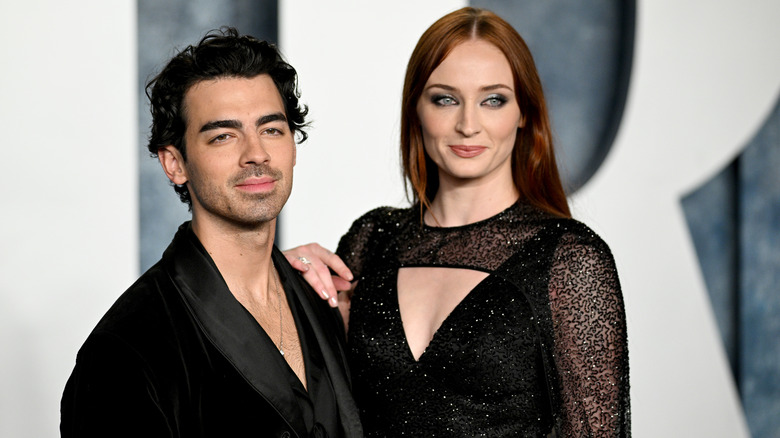 Sophie Turner with hand on Joe Jonas' shoulder