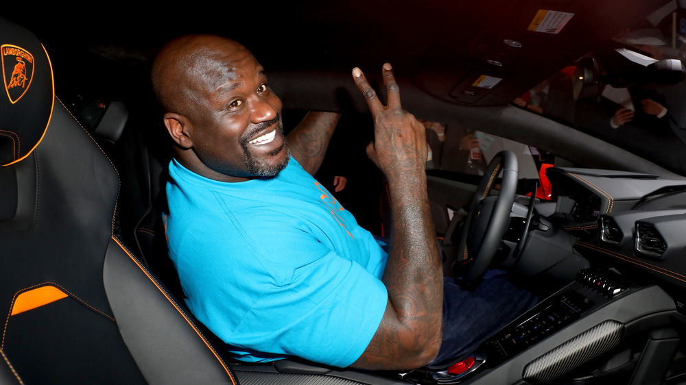 Shaquille O'Neal sitting in a Lamborghini 