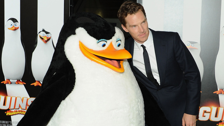 Benedict Cumberbatch poses with penguin at the "Penguins of Madagascar" premiere