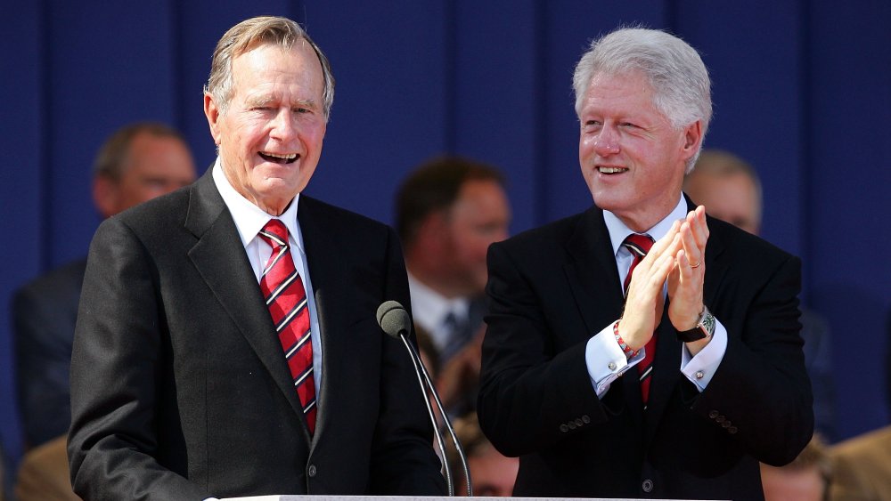 President George H.W. Bush and Bill Clinton, laughing and clapping