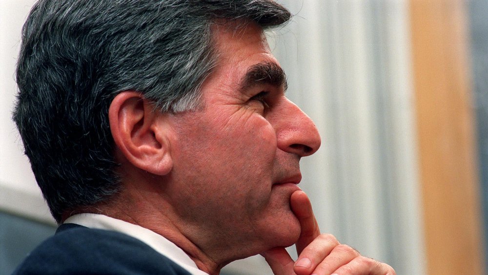 Michael Dukakis with hand resting on chin, side profile