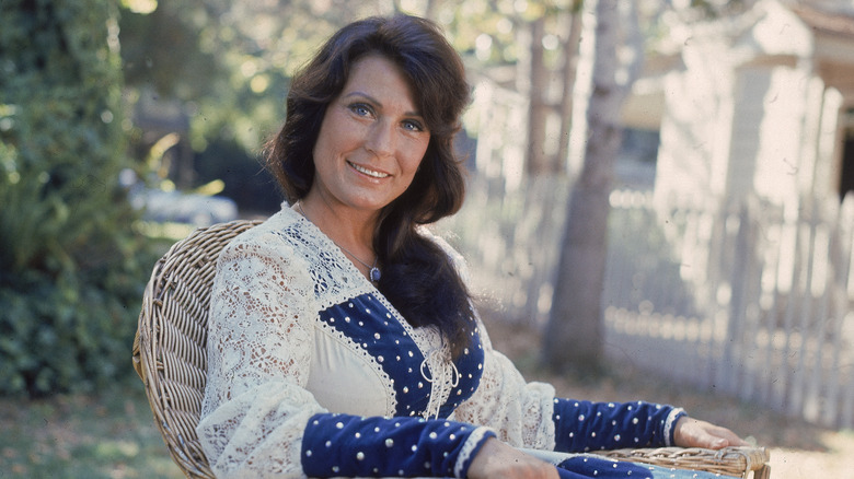 Loretta Lynn, sitting alone outside, 1970s photo 