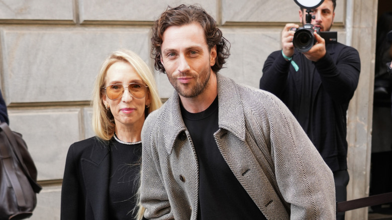 Sam and Aaron Taylor-Johnson walk arm-in-arm