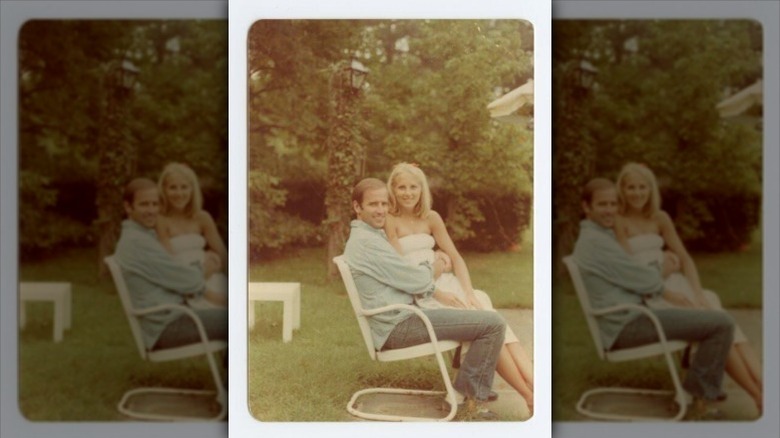 Young Jill Biden sits in Joe Biden's lap on a patio