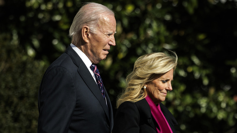 Joe and Jill Biden walk with their heads down