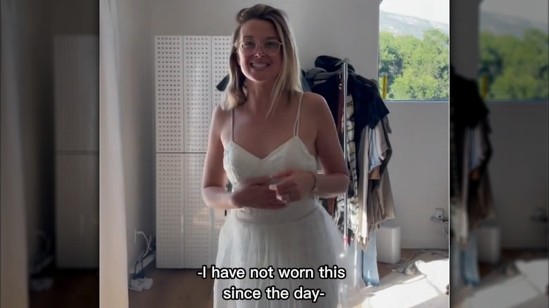 Emily Baldoni standing in her bedroom, in her wedding dress (2022)