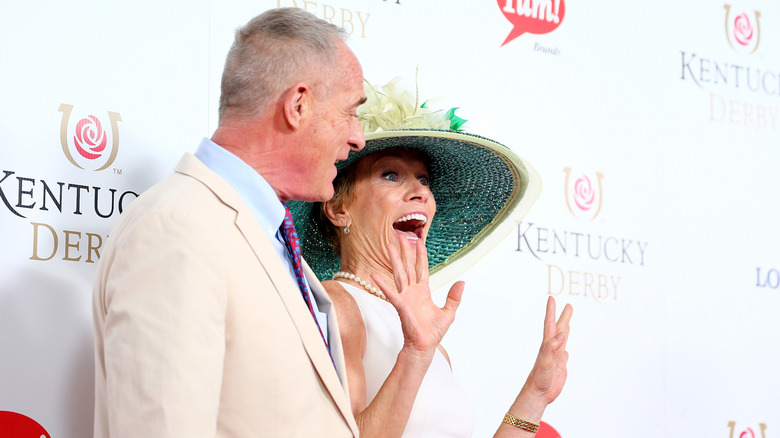 Barbara Corcoran posing alongside her husband Bill Higgins at the Kentucky Derby.