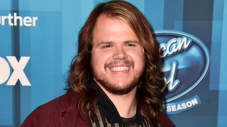 Caleb Johnson smiling at the American Idol finale tour in April 2016