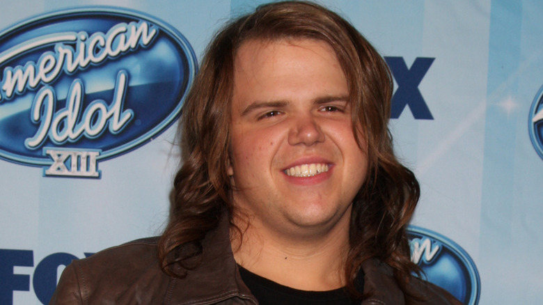 Caleb Johnson smiling for photographers at the American Idol season 13 finale in Los Angeles in May 2014