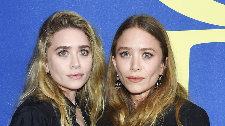 Mary-Kate Olsen and Ashley Olsen posing