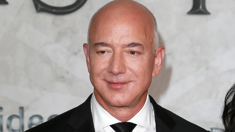 Jeff Bezos posing in black suit