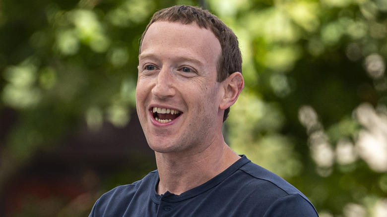 Mark Zuckerberg laughing in blue shirt