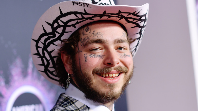 Post Malone smiling in hat