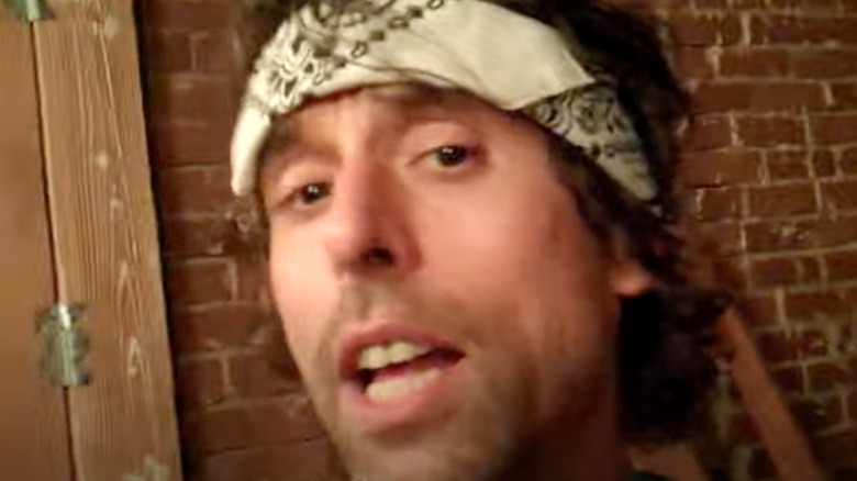 Pete McNeal speaking into camera while wearing a bandana headband