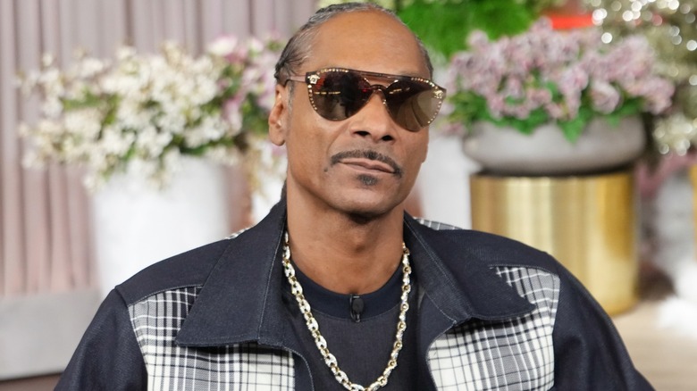 Snoop Dogg wears a black checked shirt