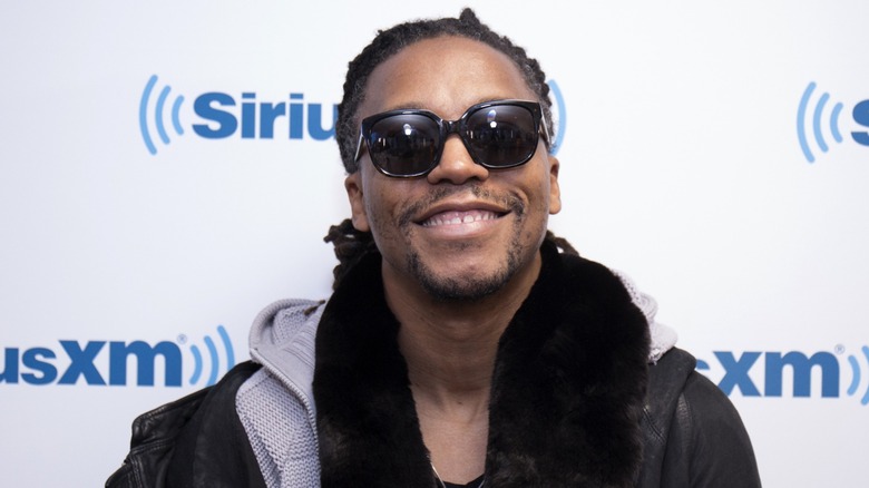 Lupe Fiasco is all smiles in dark sunglasses