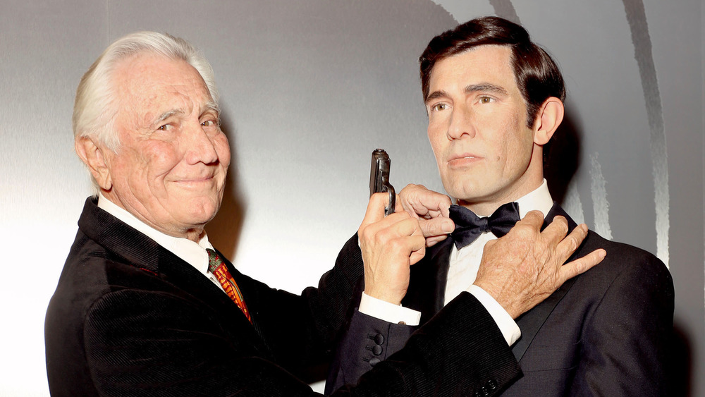 George Lazenby poses with his James Bond waxwork
