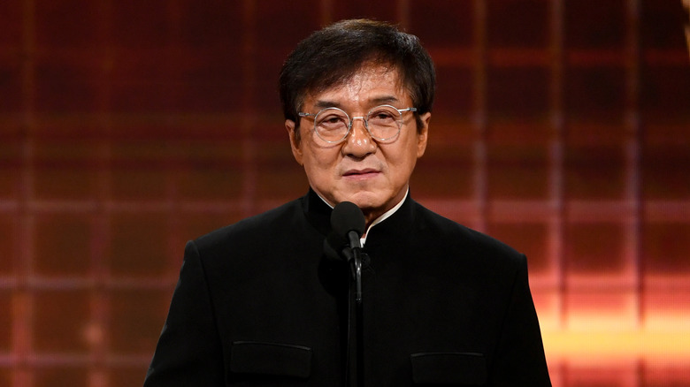 Jackie Chan speaking into microphone