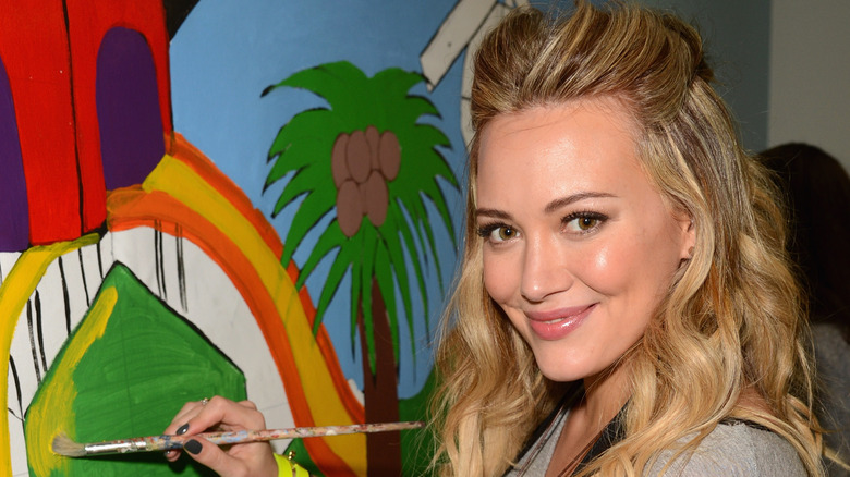 Hilary Duff painting for charity in 2012