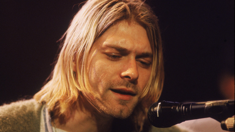 Kurt Cobain performing on stage 