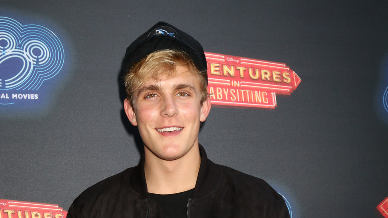 Jake Paul smiling and wearing hat