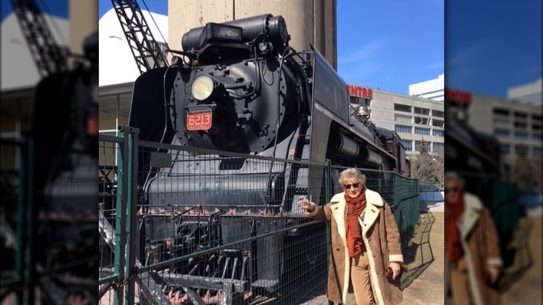 Rod Stewart standing by train