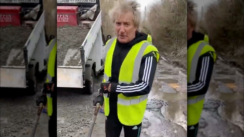 Rod Stewart holding shovel 