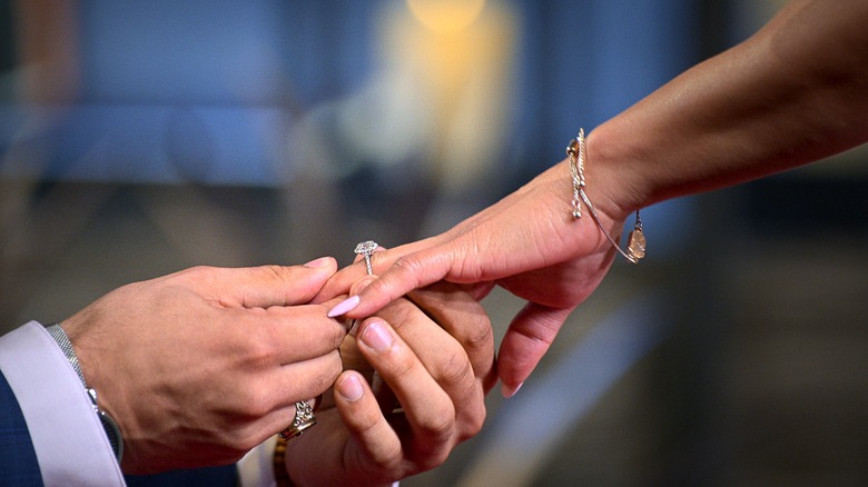 Engagement ring being slid onto finger