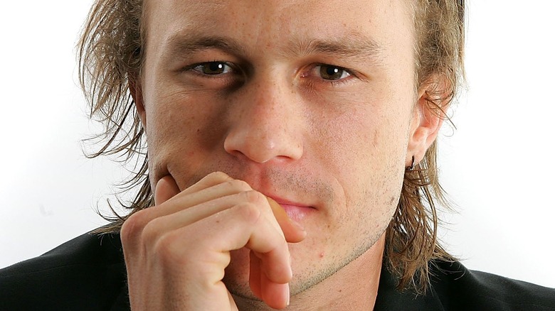 Heath Ledger resting his face in hand