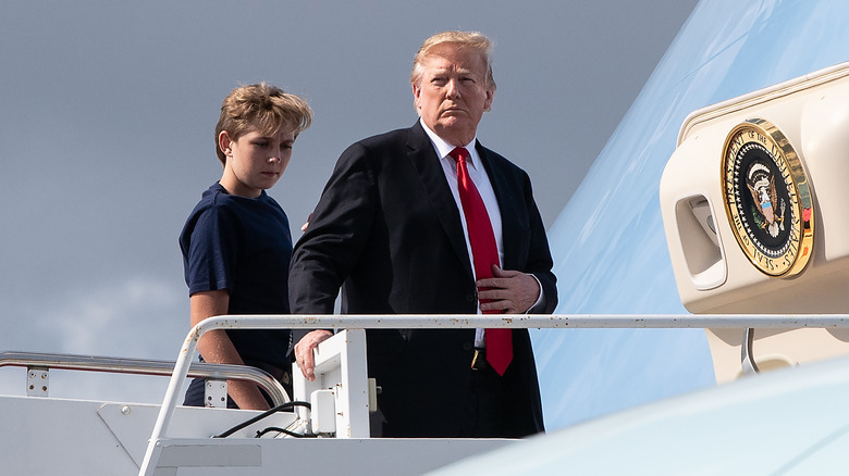Barron Trump and Donald Trump boarding airplane