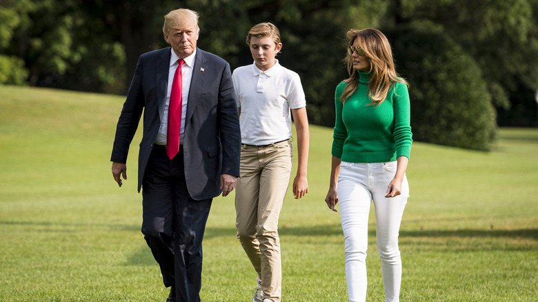 Donald Trump, Barron Trump, and Melania Trump walking outside