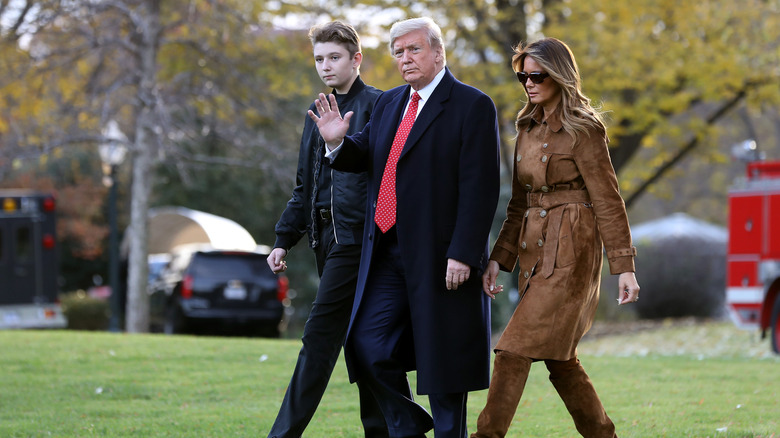 Barron Trump at an event walking with his parents