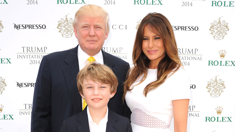 Barron Trump posing with his parents