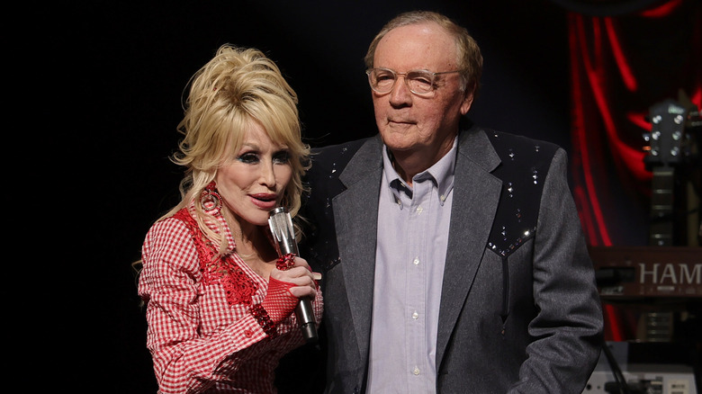 Dolly Parton and James Patterson embracing