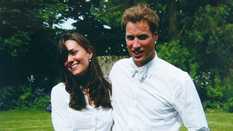 Young Kate Middleton and Prince William posing outside