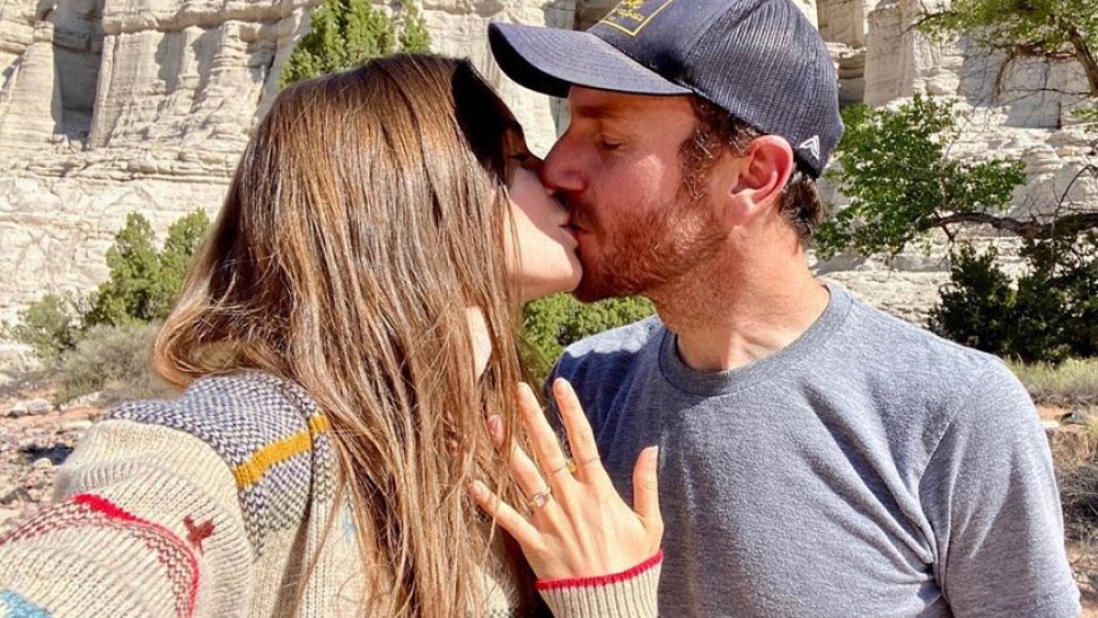 Lily Collins and Charlie McDowell kissing in their engagement announcement 