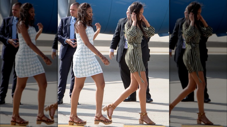 Sasha Obama and Malia Obama walking on a tarmac in 2016