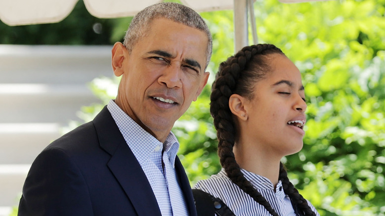 Barack Obama and Malia Obama walking out of the White House