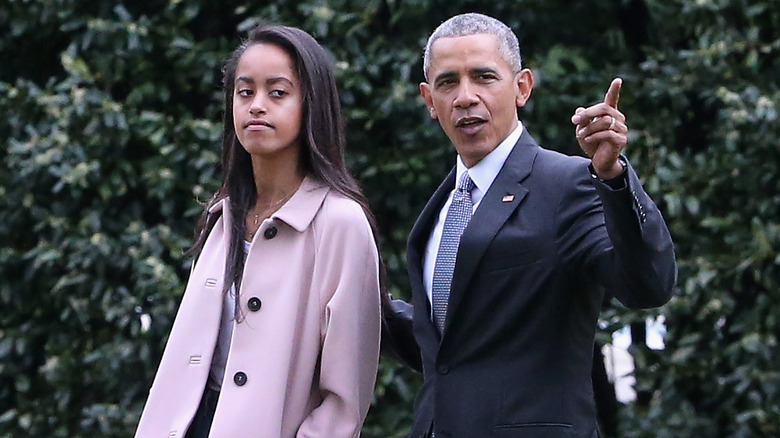 Barack Obama walking with his daughter Malia 