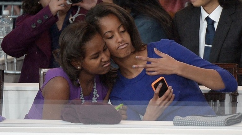 Sasha and Malia Obama taking a selfie